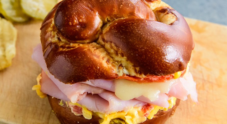 Ham, Swiss, and Pimento Cheese Melt on a Pretzel Bun