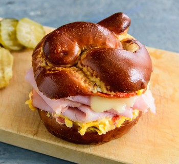 Ham, Swiss, and Pimento Cheese Melt on a Pretzel Bun