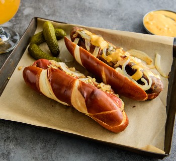 Bratwurst with Caramelized Onions and Stone Ground Mustard on a Pretzel Bun